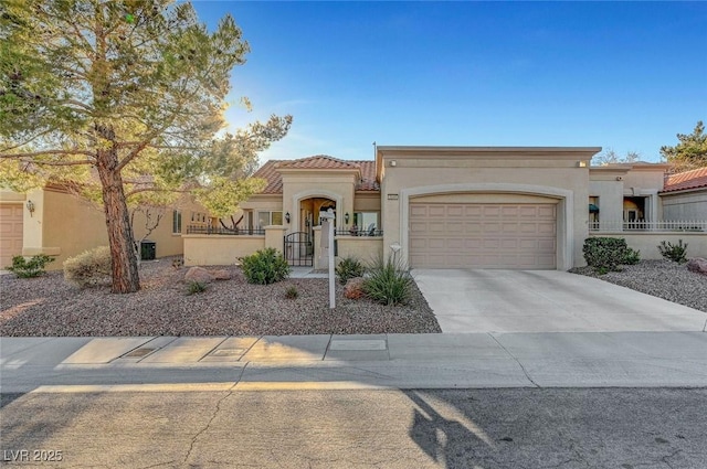 mediterranean / spanish-style house featuring a garage, a fenced front yard, driveway, and stucco siding