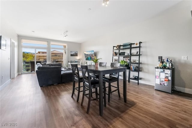 dining space with dark hardwood / wood-style floors