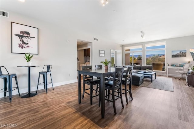 dining space featuring wood-type flooring