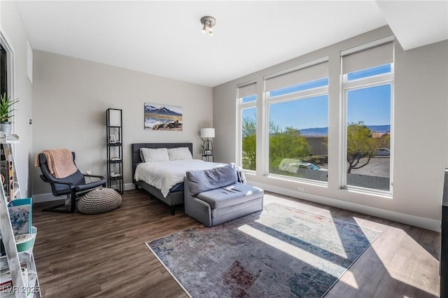 bedroom with dark hardwood / wood-style floors