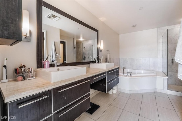 bathroom featuring tile patterned floors, separate shower and tub, and vanity