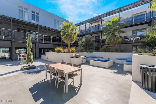 view of patio / terrace with an outdoor fire pit