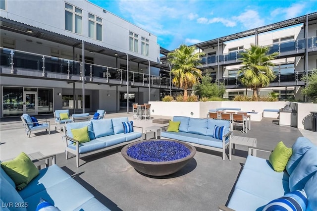 view of home's community with a patio and an outdoor living space