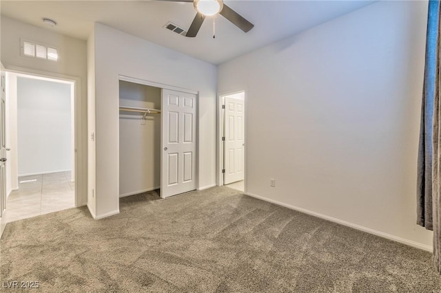 unfurnished bedroom featuring a closet, ceiling fan, and carpet flooring