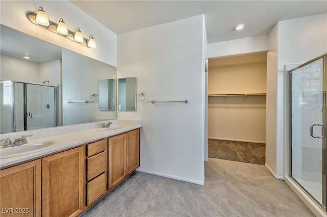 bathroom featuring vanity, tile patterned flooring, and an enclosed shower