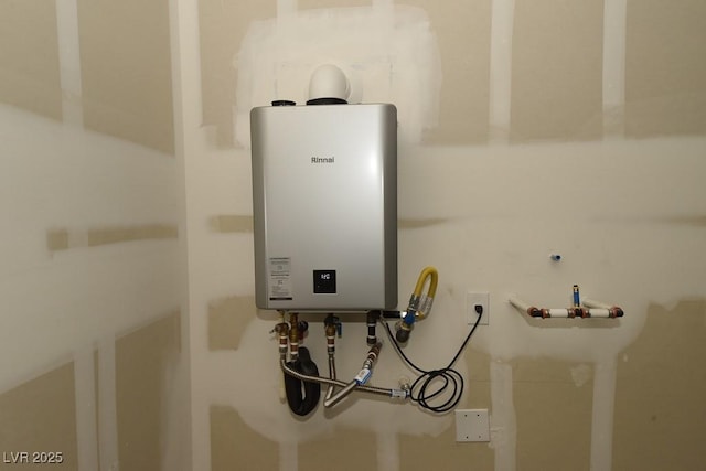 utility room featuring water heater