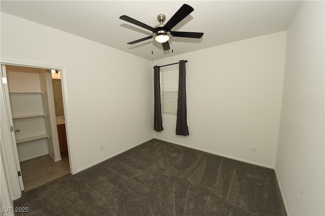 unfurnished bedroom featuring dark carpet and ceiling fan