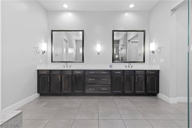 bathroom featuring tile patterned floors, vanity, and a shower with shower door