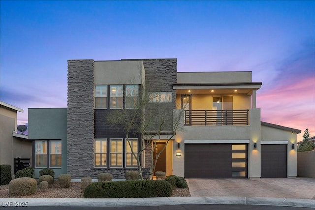 modern home with a garage and a balcony