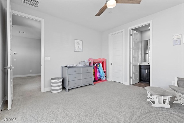 bedroom with ceiling fan, carpet floors, and ensuite bathroom