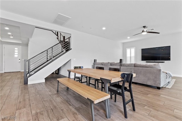 dining space featuring ceiling fan and light wood-type flooring