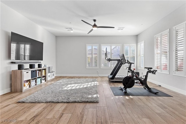 exercise room featuring light wood-type flooring and ceiling fan