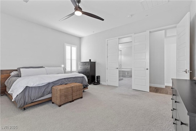 carpeted bedroom featuring connected bathroom and ceiling fan