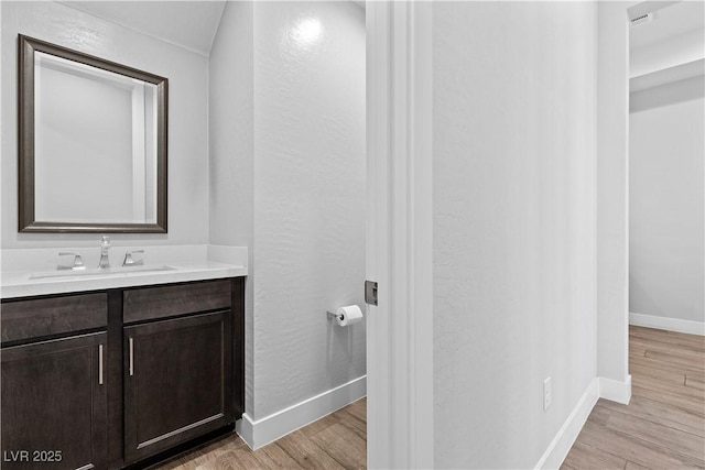 bathroom with vanity and hardwood / wood-style floors