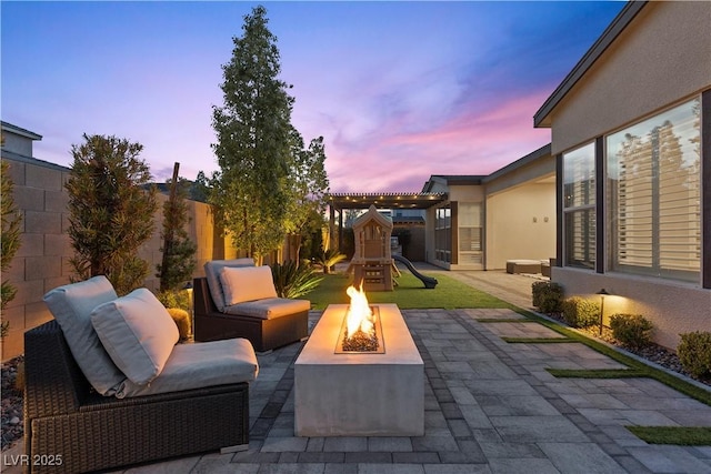 patio terrace at dusk with a playground and a fire pit