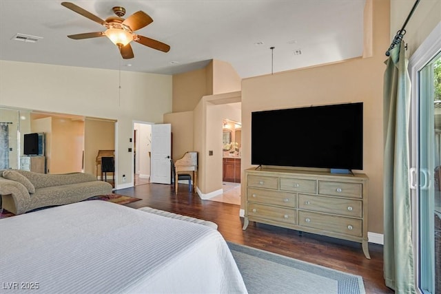 688 Quiet Stream Ct, Henderson, NV 89052 - bedroom featuring dark wood finished floors, baseboards, ensuite bathroom, and high vaulted ceiling