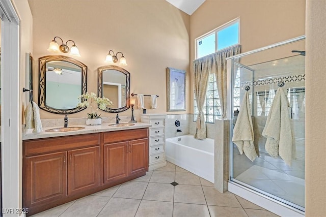 688 Quiet Stream Ct, Henderson, NV 89052 - full bathroom featuring a garden tub, double vanity, a shower stall, and tile patterned flooring