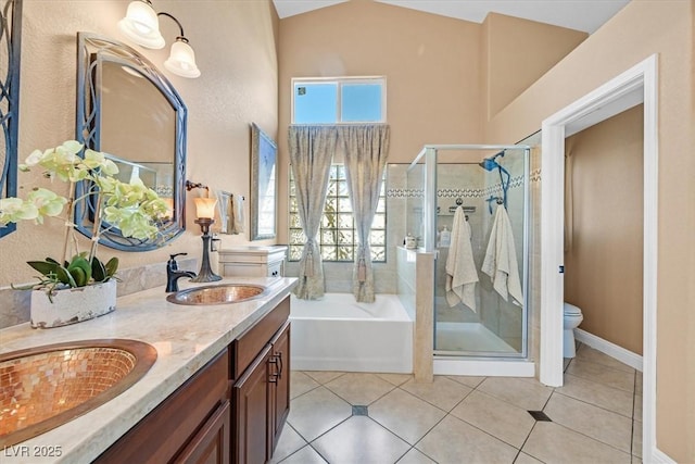 688 Quiet Stream Ct, Henderson, NV 89052 - bathroom with a bath, double vanity, a stall shower, toilet, and vaulted ceiling