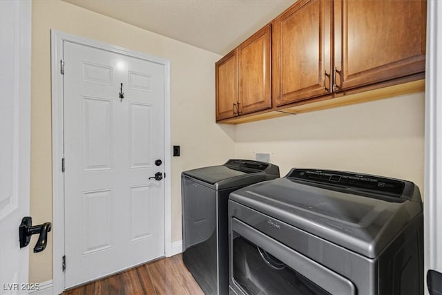 688 Quiet Stream Ct, Henderson, NV 89052 - laundry room featuring washer and dryer, wood finished floors, cabinet space, and baseboards