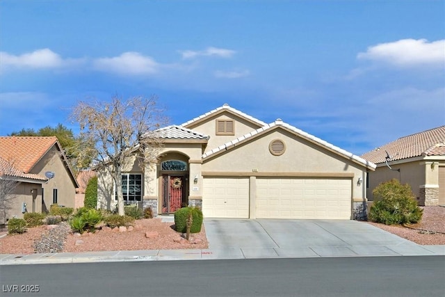 688 Quiet Stream Ct, Henderson, NV 89052 - mediterranean / spanish-style house with a garage, stone siding, stucco siding, concrete driveway, and a tiled roof