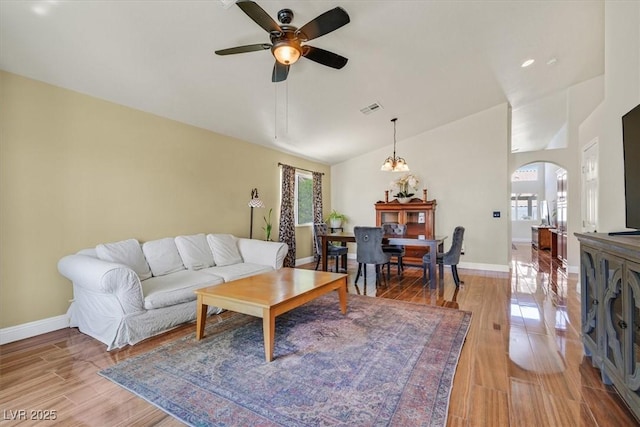 688 Quiet Stream Ct, Henderson, NV 89052 - living room featuring healthy amount of natural light, arched walkways, ceiling fan, light wood-style flooring, and high vaulted ceiling