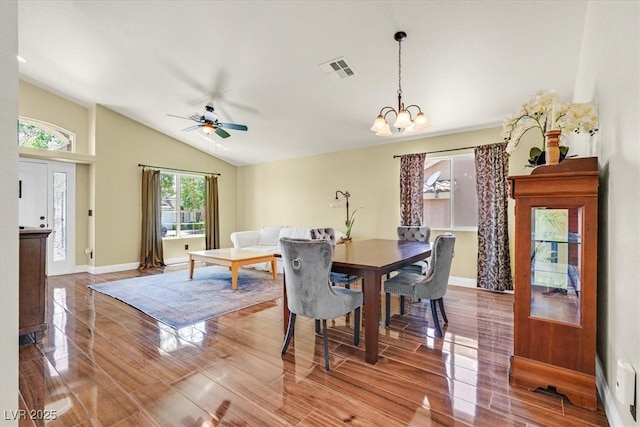 688 Quiet Stream Ct, Henderson, NV 89052 - dining area featuring vaulted ceiling, ceiling fan, a chandelier, wood finished floors, and baseboards
