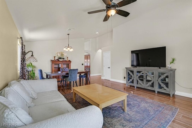 688 Quiet Stream Ct, Henderson, NV 89052 - living area featuring arched walkways, ceiling fan, baseboards, wood finished floors, and a chandelier