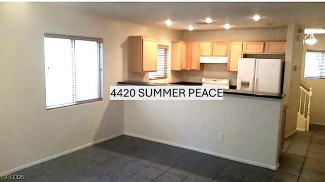 kitchen featuring white fridge with ice dispenser, light brown cabinets, under cabinet range hood, and baseboards