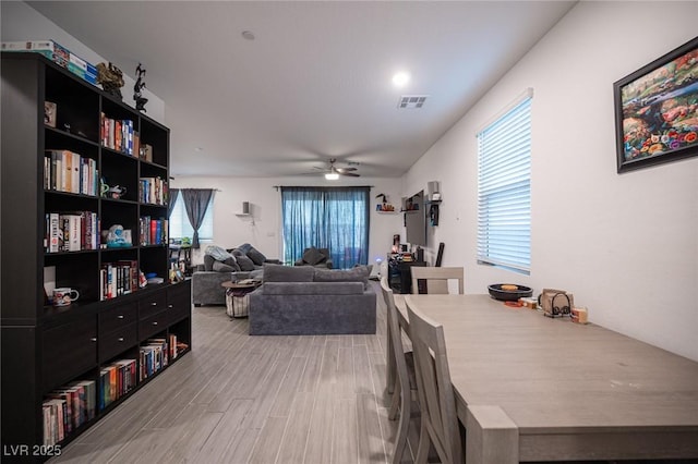 dining room with hardwood / wood-style flooring and ceiling fan