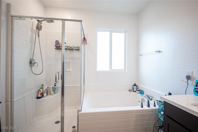 bathroom featuring vanity and shower with separate bathtub