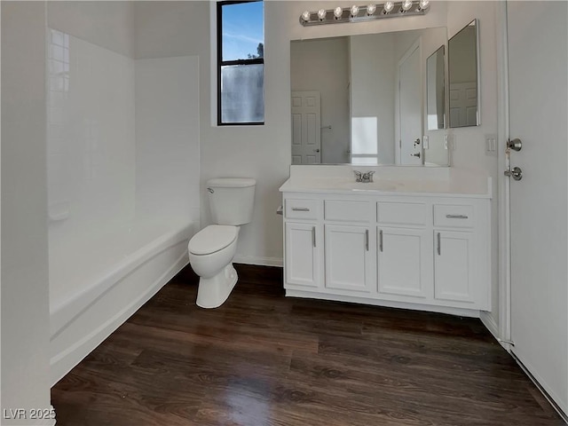 bathroom featuring wood-type flooring, vanity, and toilet