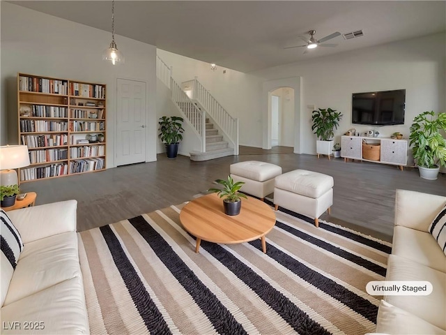 living room featuring hardwood / wood-style floors and ceiling fan