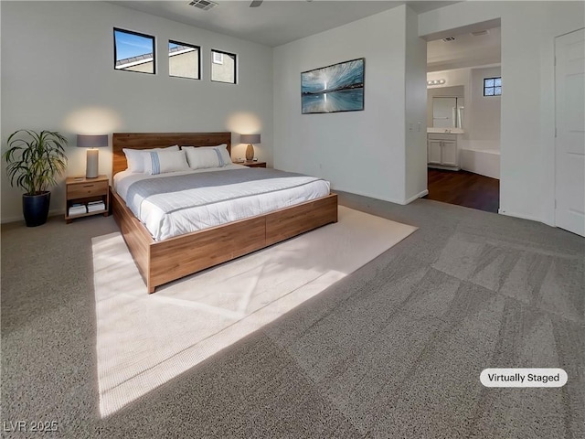 carpeted bedroom featuring connected bathroom