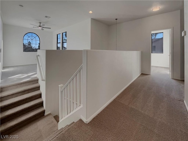 hall featuring light colored carpet