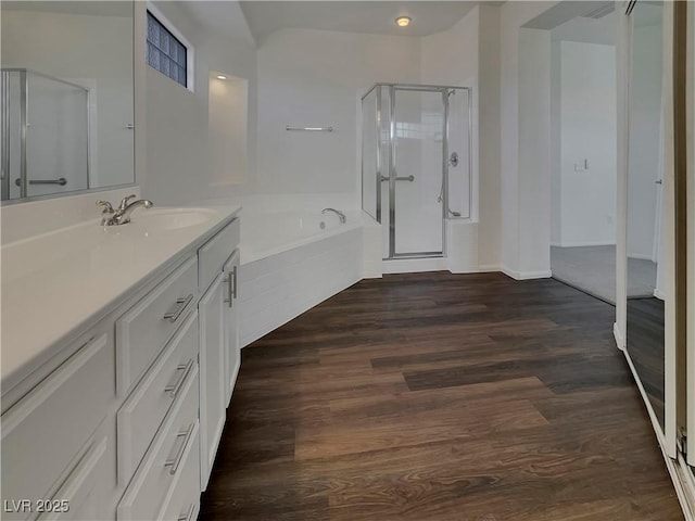 bathroom with shower with separate bathtub, hardwood / wood-style flooring, and vanity