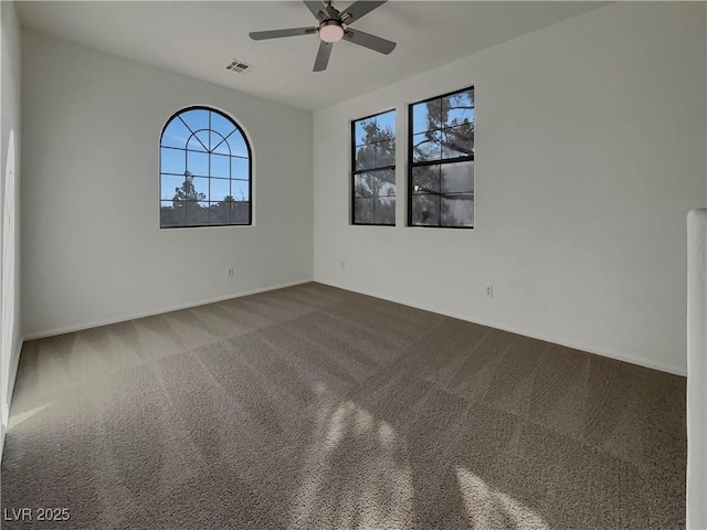 unfurnished room with carpet flooring and ceiling fan