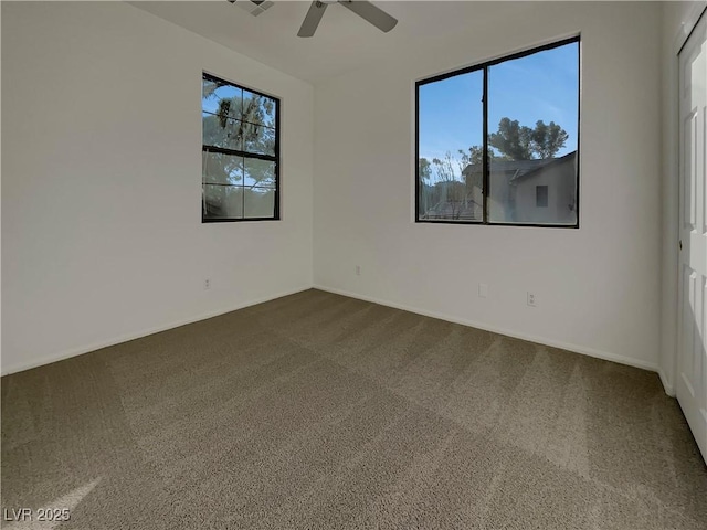 spare room with ceiling fan, carpet flooring, and a wealth of natural light