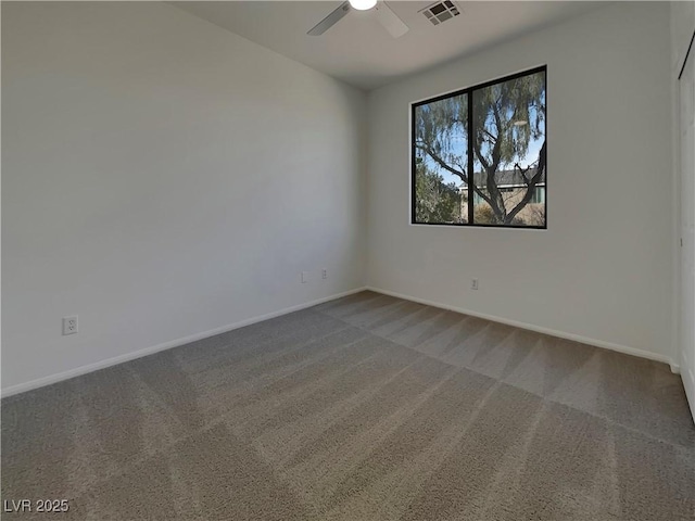 empty room with ceiling fan and carpet flooring