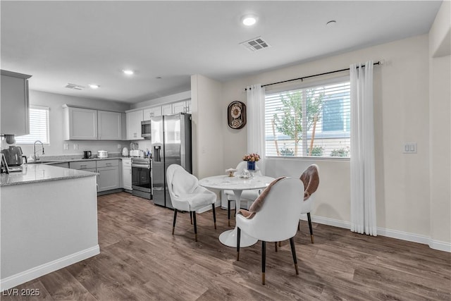 dining space featuring sink and dark hardwood / wood-style floors