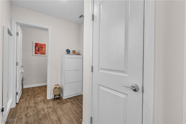 corridor with light hardwood / wood-style flooring