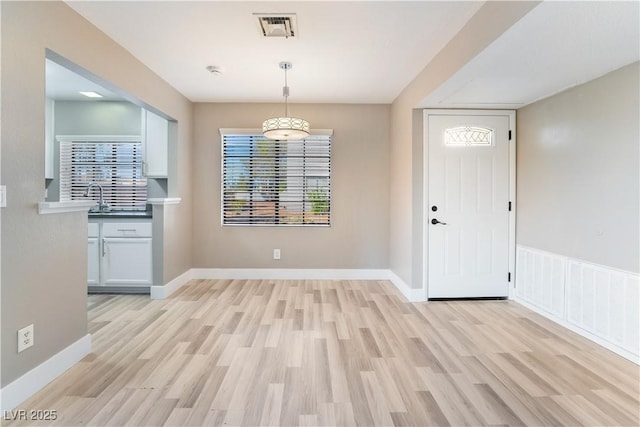 entrance foyer with light wood-type flooring and sink