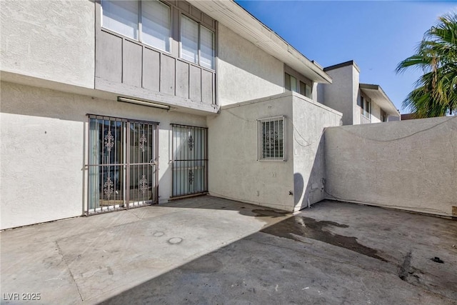 doorway to property with a patio area