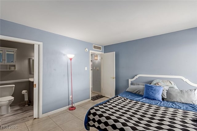 bedroom featuring light tile patterned floors and connected bathroom