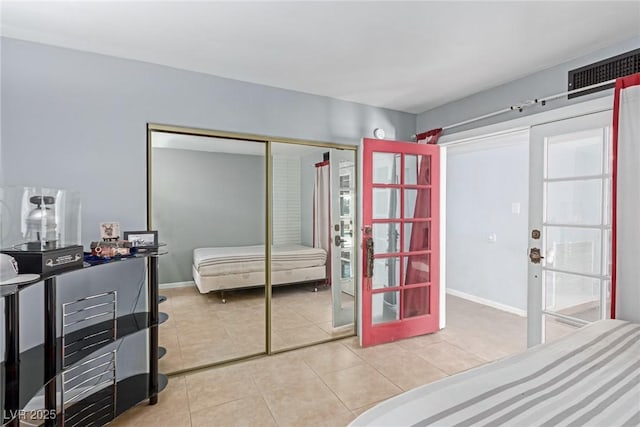 tiled bedroom featuring a closet