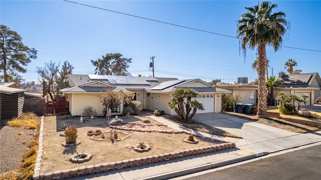 ranch-style home featuring a garage and solar panels