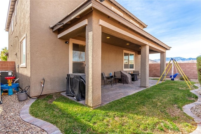 view of patio / terrace with a mountain view, area for grilling, and a playground