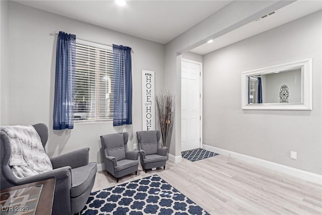 sitting room with light hardwood / wood-style floors