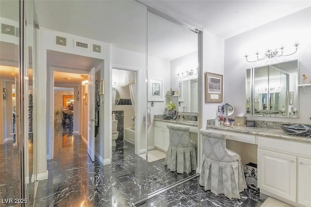730 S Royal Crest Cir Unit 424, Las Vegas, NV 89169 - full bathroom featuring toilet, marble tiled floors, vanity, and baseboards