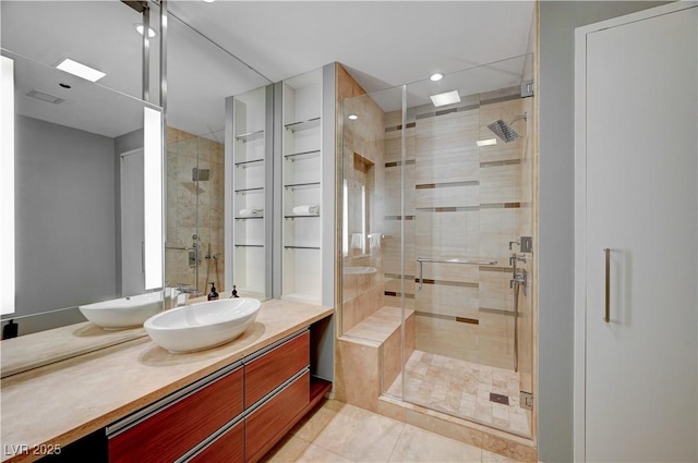 bathroom with a shower with door, tile patterned flooring, and vanity