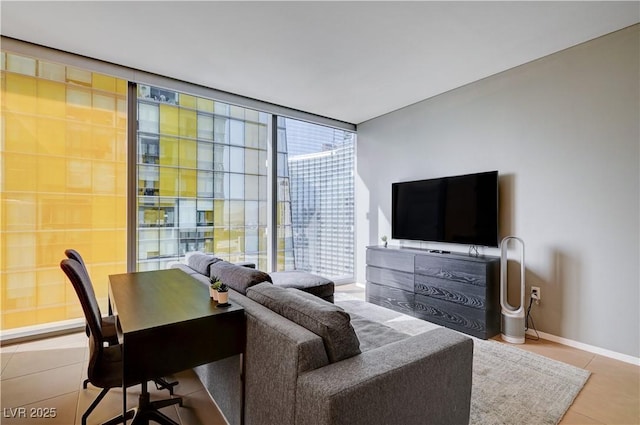 tiled living room featuring floor to ceiling windows